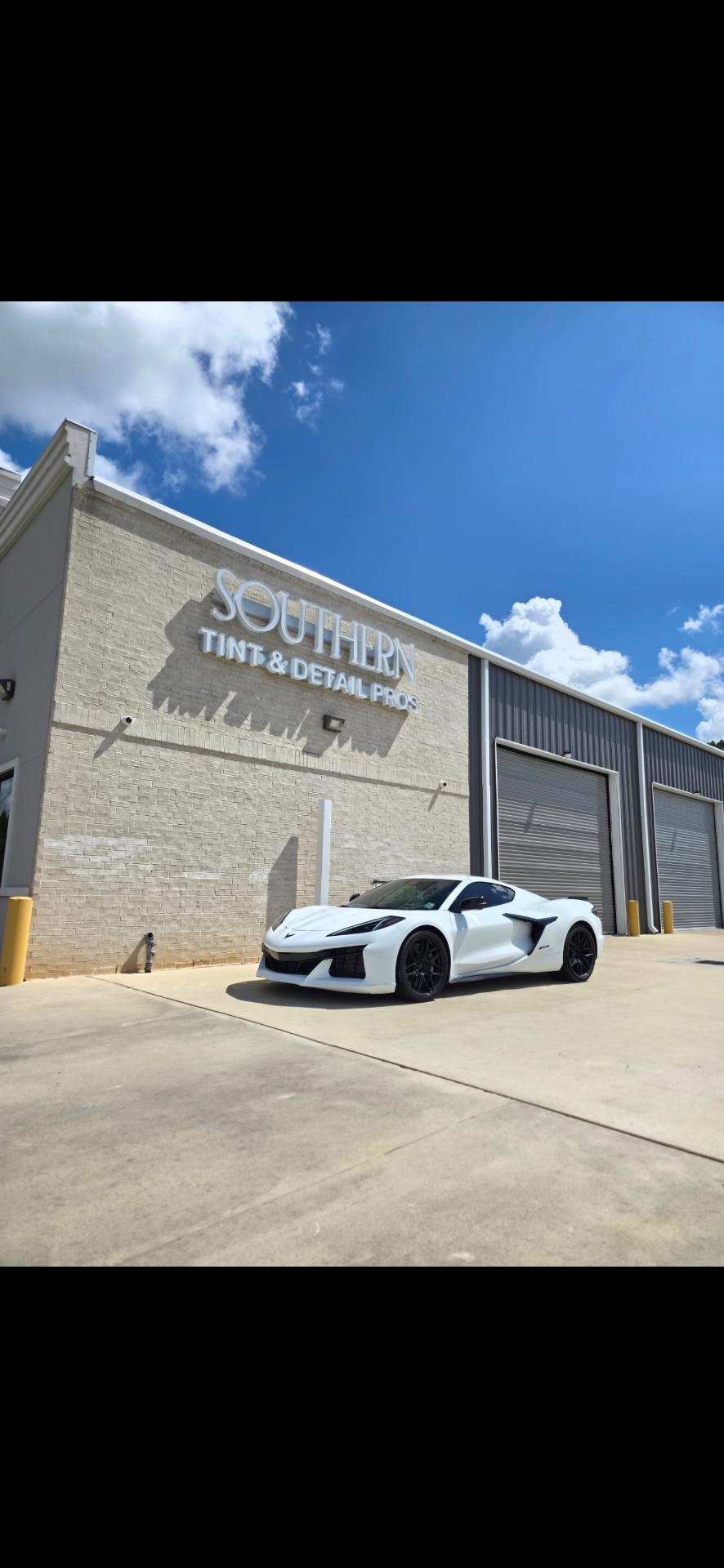 Southern Tint & Detail Pros shop with a white Corvette Z06
